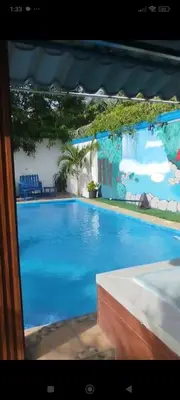 a large swimming pool with a blue pool at Villa Luz in Andrés