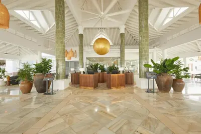 a lobby with potted plants in a building at Bahia Principe Luxury Esmeralda All Inclusive - Newly Renovated in Punta Cana