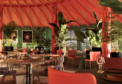 a restaurant with tables and chairs and a red roof at Bahia Principe Luxury Esmeralda All Inclusive - Newly Renovated in Punta Cana