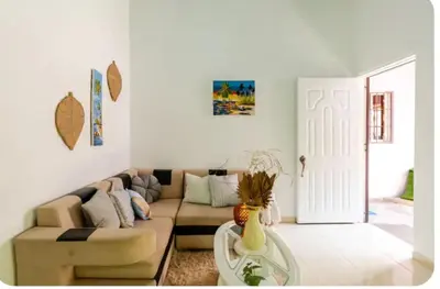 a living room with a couch and a table at Escape to Puerto Plata, Cozy 2BR Loft in Las Mercedes, 5 Min from Beaches in Isabel de Torres