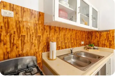 a kitchen with a sink and a stove at Escape to Puerto Plata, Cozy 2BR Loft in Las Mercedes, 5 Min from Beaches in Isabel de Torres