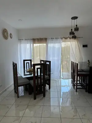 a dining room with a table and chairs at Apartamentos victoria in Las Terrenas