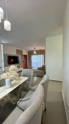 a living room with a table and some chairs at Hospedaje Lujoso en Boca Chica in Santo Domingo