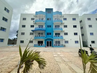 a large white building with a blue at Hospedaje Lujoso en Boca Chica in Santo Domingo