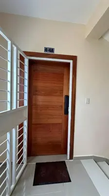 a wooden door in a room with a hallway at Hospedaje Lujoso en Boca Chica in Santo Domingo