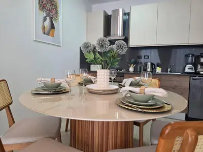 a dining room table with plates and wine glasses at Luxury Apartment IZHA 202 in La Laguna
