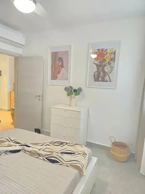 a bedroom with a bed and two pictures on the wall at Luxury Apartment IZHA 202 in La Laguna