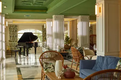 a living room with a couch and a piano at Cayo Levantado Resort - All Inclusive in Santa Bárbara de Samaná