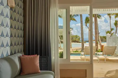a living room with a couch and a view of the ocean at Cayo Levantado Resort - All Inclusive in Santa Bárbara de Samaná