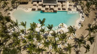 an aerial view of a resort pool with palm trees at Cayo Levantado Resort - All Inclusive in Santa Bárbara de Samaná