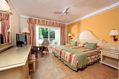 a hotel room with a bed and a television at Bahia Principe Grand El Portillo - All Inclusive in Las Terrenas