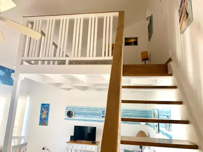 a staircase in a house with a view of the ocean at Beach Day at CadaquesCaribe Bayahibe in Bayahibe