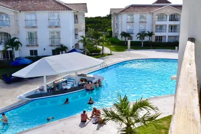 a group of people in a swimming pool at a hotel at Beach Day at CadaquesCaribe Bayahibe in Bayahibe
