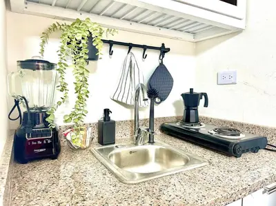 a kitchen counter with a sink and a blender at Villa Olímpica Doble Vía in Marilópez