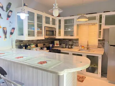 a kitchen with white cabinets and a white counter top at Casa de adela in Cruce de Veragua