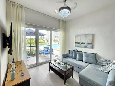 a living room with a couch and a table at Melody 2BDR Condo with Pool View in Coral Bay #2 in Punta Cana