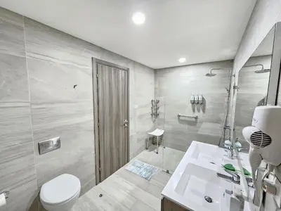 a bathroom with a toilet and a sink and a shower at Melody 2BDR Condo with Pool View in Coral Bay #2 in Punta Cana