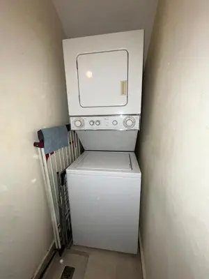 a small white washer and dryer in a room at Luxury Beach Penthouse with Pool, BBQ, AC, Wi-Fi, 5-Min Walk to El Cortecito & Bavaro Beaches, Punta Cana in Punta Cana