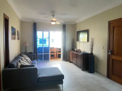 a living room with a couch and a sliding glass door at Luxury Beach Penthouse with Pool, BBQ, AC, Wi-Fi, 5-Min Walk to El Cortecito & Bavaro Beaches, Punta Cana in Punta Cana