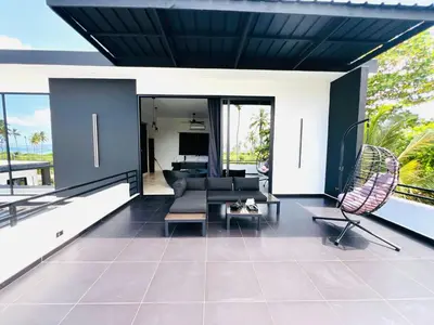 a living room with a couch and a chair at Casa B&W, Villa luxueuse Exceptionnelle, 8 personnes, à 1 min de la plage in Las Galeras
