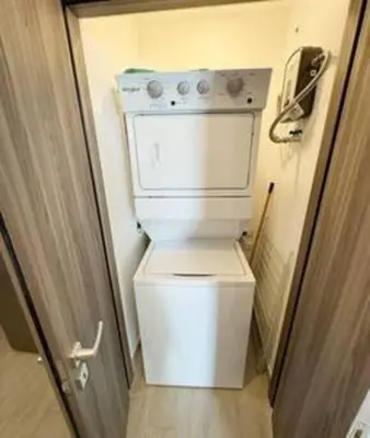 a white toilet in a small room with a door at Brand New beach and golf condo in Punta Cana in Punta Cana