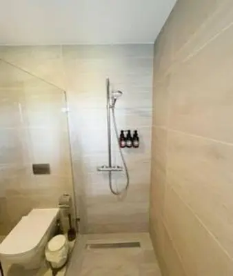 a bathroom with a shower and a toilet at Brand New beach and golf condo in Punta Cana in Punta Cana