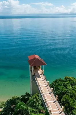a building with a roof on top of the water at Eurostars Grand Cayacoa in Santa Bárbara de Samaná