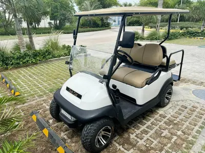 a small golf cart parked in a driveway at Peaceful haven overlooking the golf course in Punta Cana