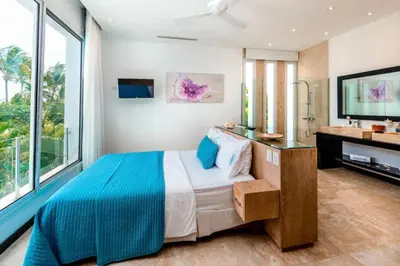 a bedroom with a large bed and a television at New private luxury villa in Punta Cana in Punta Cana