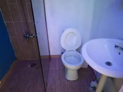 a bathroom with a toilet and a sink at Acogedor apartamento entero in Mandinga