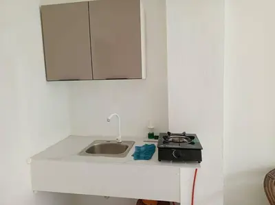 a kitchen counter with a sink and a stove at Acogedor apartamento entero in Mandinga
