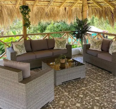 a living room with two couches and a table at Villa las Rosas JP in Bayaguana