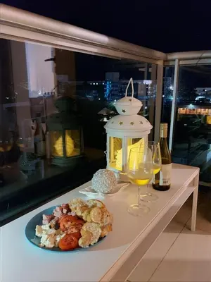 a table with a plate of food and a glass of wine at Boca chica Apartment Near the bech in Boca Chica