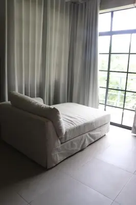 a bed in a room with a large window at Villa Cantares del Rio in La Cuaba