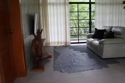 a living room with a couch and a window at Villa Cantares del Rio in La Cuaba