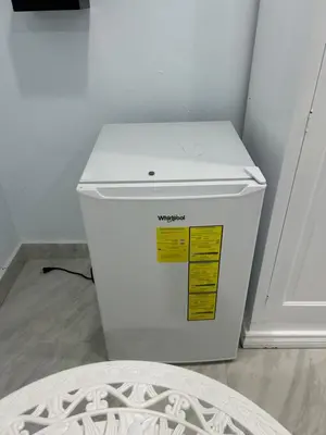 a white refrigerator with a yellow sticker on it at Hotel Hannabi in Boca Chica
