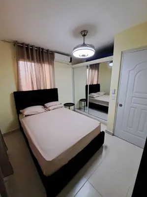 a bedroom with a bed and a mirror at Encantador Apartamento Pequeño in Hornillo