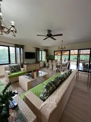 a living room with a large couch and a table at Villa RG in Jarabacoa