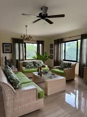 a living room with couches and a ceiling fan at Villa RG in Jarabacoa