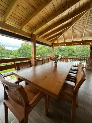 a large wooden table and chairs in a room at Villa RG in Jarabacoa