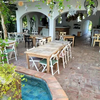 a large wooden table and chairs in a patio at Vibe Residence Hotelstyle NO KITCHEN STUDIO close to beach in La Laguna