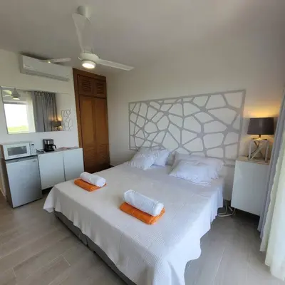 a bedroom with a large bed with two towels on it at Vibe Residence Hotelstyle NO KITCHEN STUDIO close to beach in La Laguna