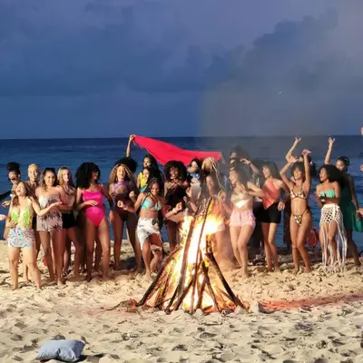 a group of people standing around a fire on the beach at Vibe Residence Hotelstyle NO KITCHEN STUDIO close to beach in La Laguna