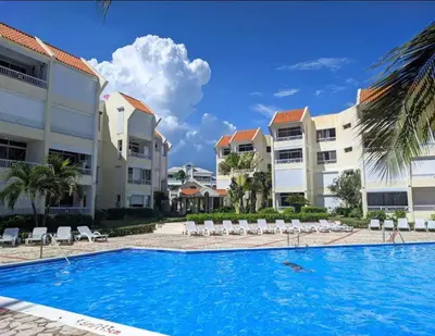 a pool in front of some apartment buildings at Albatros by R&R 2 in Villas del Mar