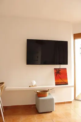 a living room with a flat screen tv on a wall at Albatros by R&R 2 in Villas del Mar
