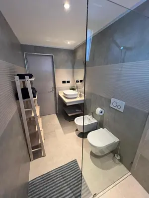 a bathroom with a toilet and a sink and a mirror at Słoneczny apartament AC WiFi in La Laguna