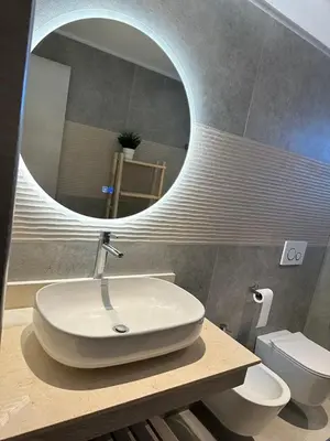 a bathroom with a white sink and a mirror at Słoneczny apartament AC WiFi in La Laguna