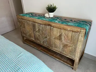 a wooden dresser with a potted plant on top of it at Słoneczny apartament AC WiFi in La Laguna