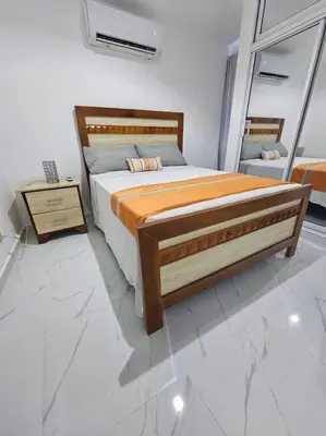 a bedroom with a large bed and a mirror at vista a toda la ciudad y montaña in San Felipe de Puerto Plata
