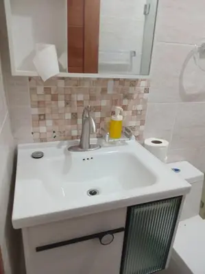 a bathroom with a white sink and a toilet at apartamento 3 habitaciones 15 minutos aeropuerto las america in San Isidro